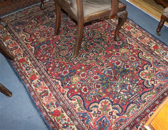 A Persian Tabriz style rug, with flowers on a red ground 214 x 150cm